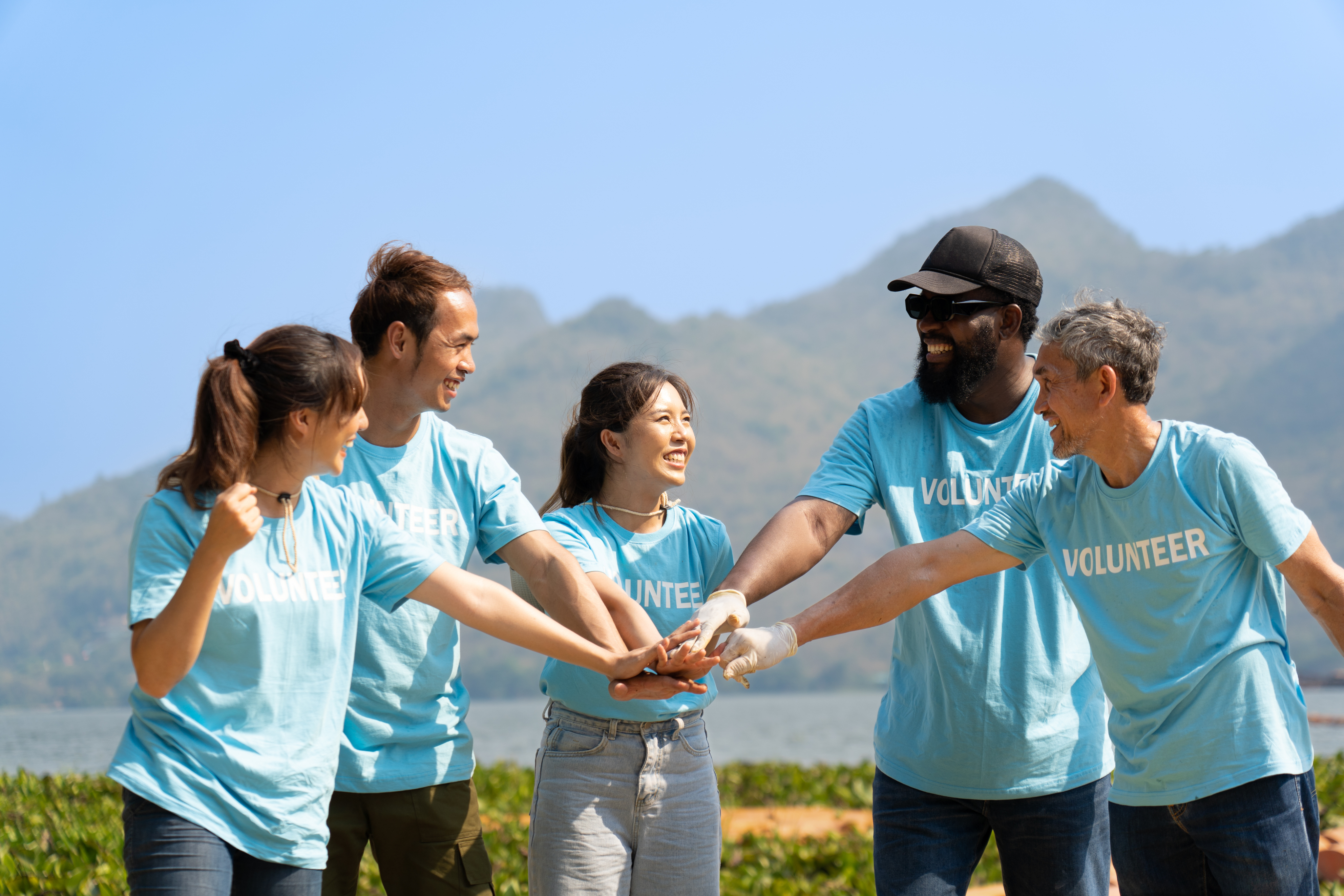 Volunteers outdoors wearing matching shirts, standing together